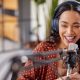 joyful multiethnic woman recording live podcast.jpg